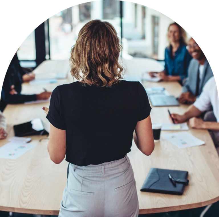Woman presenting to a business team.