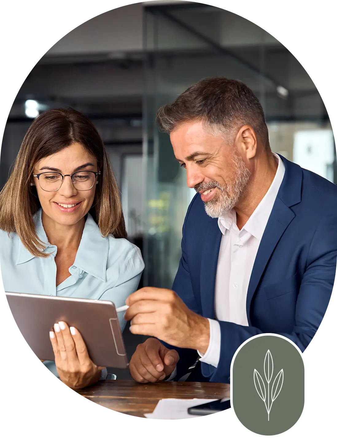 A man and woman looking at an ipad.