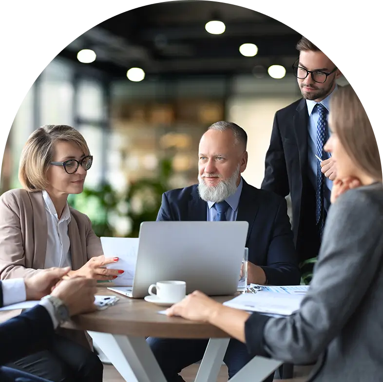 A group of people sitting around a table.