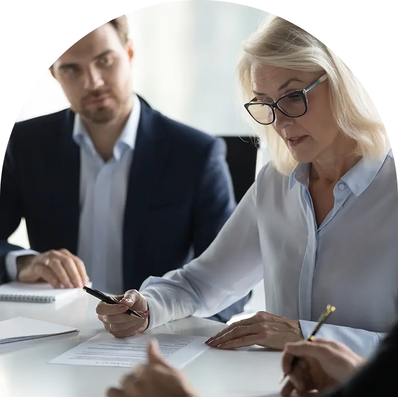 A woman is writing on paper at the table